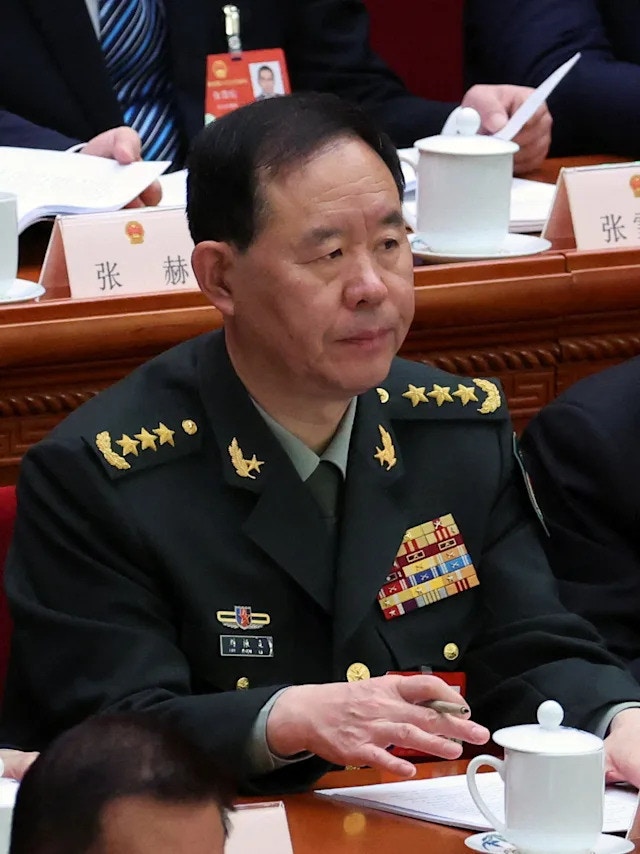 A senior PLA general at a formal assembly in Beijing; the nameplates in frame belong to other delegates. Photo: HK01