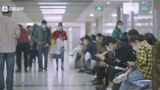 A passerby dialled 120 five times in ten minutes for a man having a heart attack in Fujin, Heilongjiang — the hospital's two emergency landlines never rang, the police's own 110 could not reach them either, and the man died less than a kilometre from care.