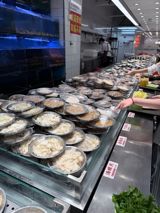 A Fuzhou hotpot brand has become China's quiet restaurant phenomenon by slashing the price of a seafood feast from around 300 yuan to barely 100, using scale, short supply chains, and a one-pot-per-diner format. The line outside its 208-table flagship is now the business story visitors post most.
