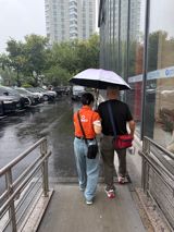 A job that barely existed a decade ago — the paid companion who walks elderly patients through China's digital-first hospitals — gets its first national rulebook on November 1, as Didi's orange-uniformed escorts roll out in Hangzhou and an ageing country reckons with how many medical visits now happen alone.