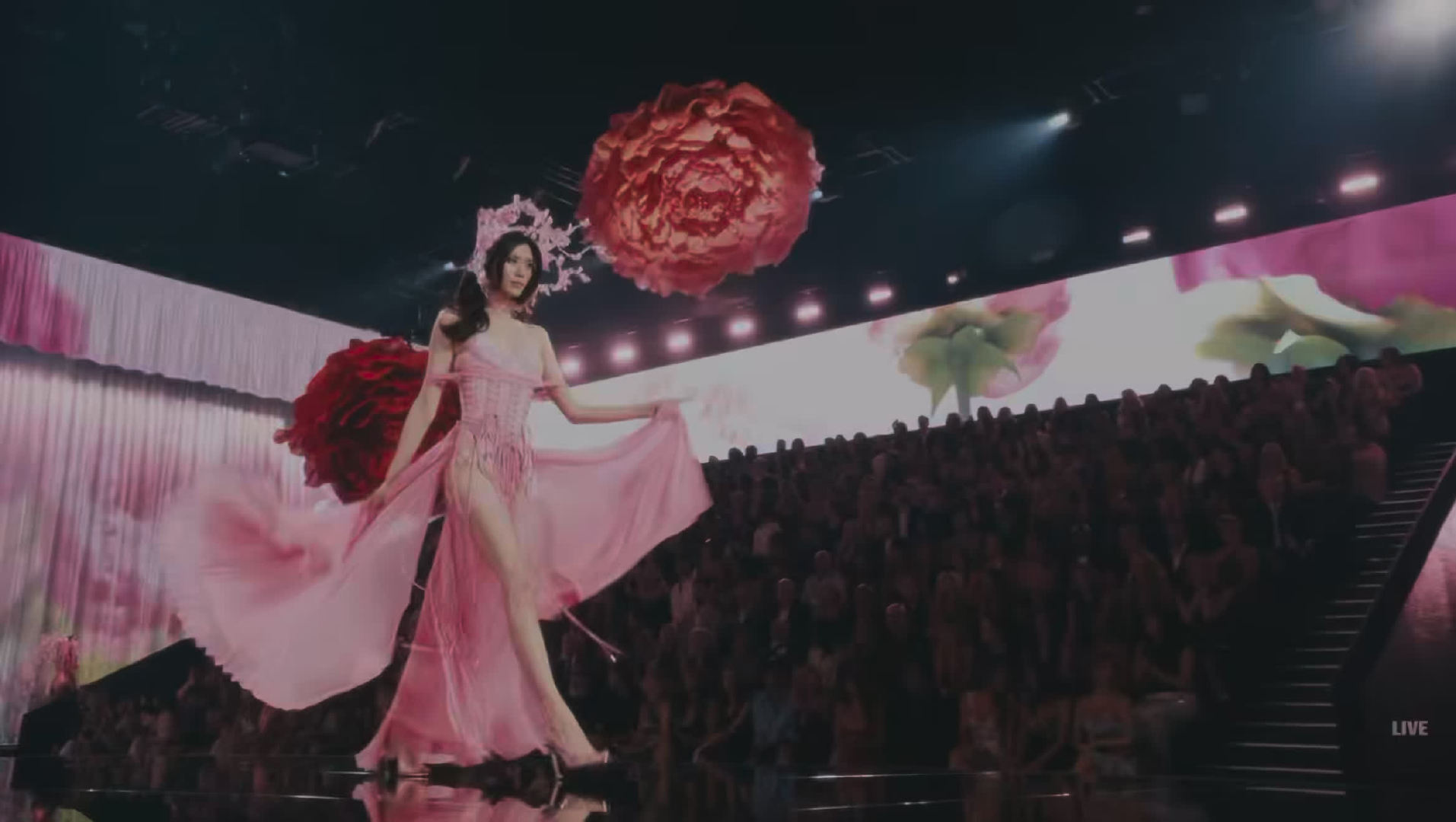 A model in a flowing pink gown on the Victoria's Secret runway, in a broadcast still. Photo: @HauteCouture_Style
