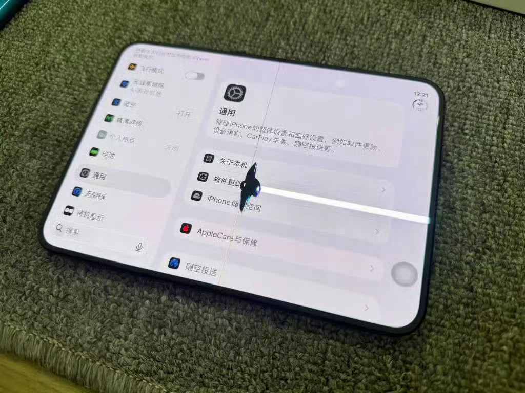 A cracked iPhone Duo screen showing a white damage line across a Settings menu. Photo: @陈震同学