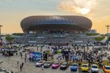 XPeng turned the MONA L05's launch into a 5,000-person owners' party in Guangzhou — cars on a red carpet, a giant pixel mural, a beach music festival — as the sub-brand courts China's young buyers with community rather than specs.