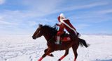 He Jiaolong, the Xinjiang official whose red-cloaked snowfield gallop made her the face of local-government tourism promotion, has died months after a January riding accident. A People's Daily memorial revealed her burial in a plain grave — and her mother's refusal to let anyone build a statue.
