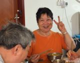 A village canteen in Luzhou, Sichuan serves free lunches to anyone over 70 — and three months in, it has not bought a single vegetable, because the elders it feeds compete to donate rice, oil and appliances instead.