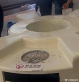 A passenger who could not avoid secondhand smoke on Ningbo station's high-speed platforms took the railway to court over ashtrays placed under bilingual no-smoking signs. The station's answer — taking down the signs — has turned a local complaint into a national argument about whether smoking is actually banned on China's platforms.