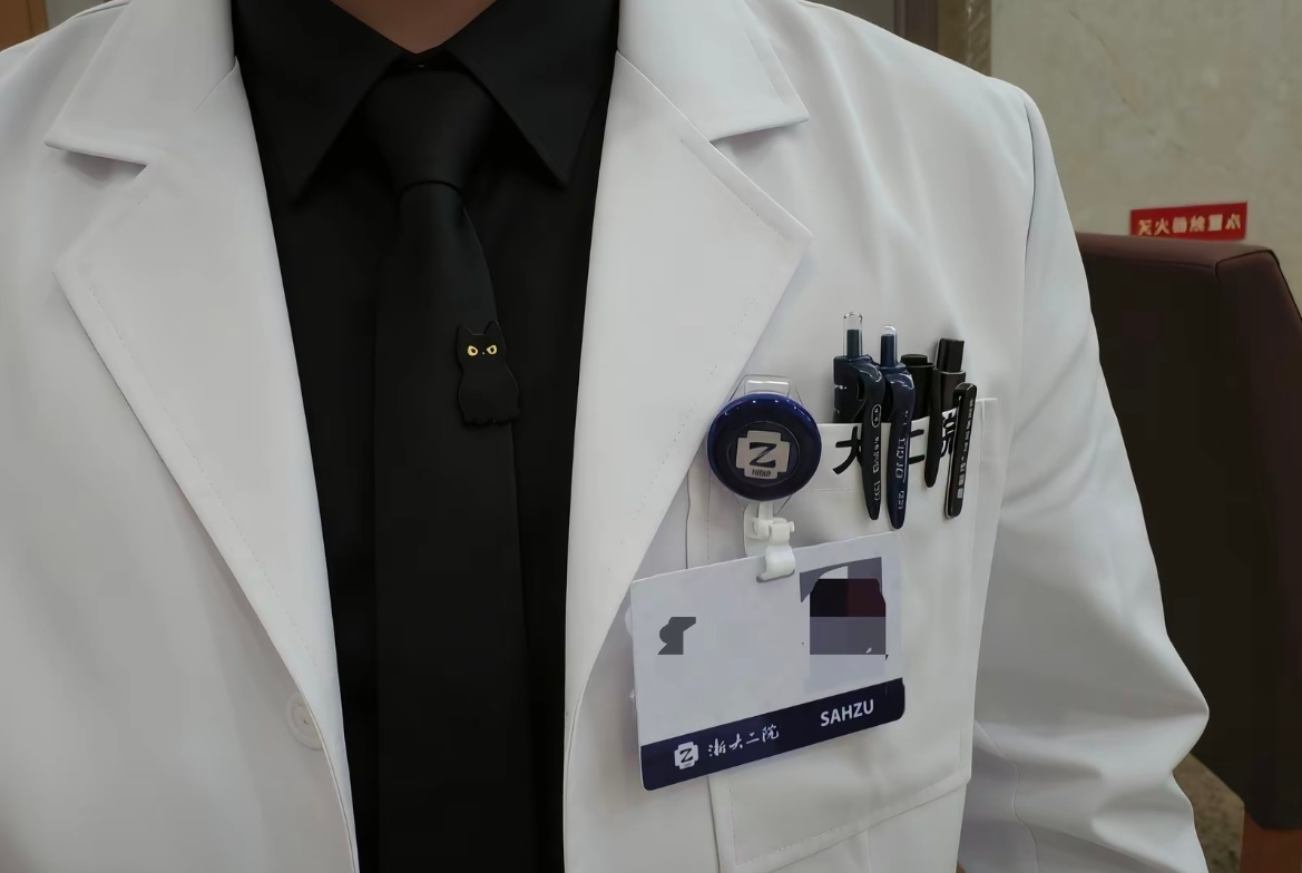 A close-up of a doctor's white coat — pens in the chest pocket, a hospital ID clipped on — one of the images that made the post feel like a study in professional polish.