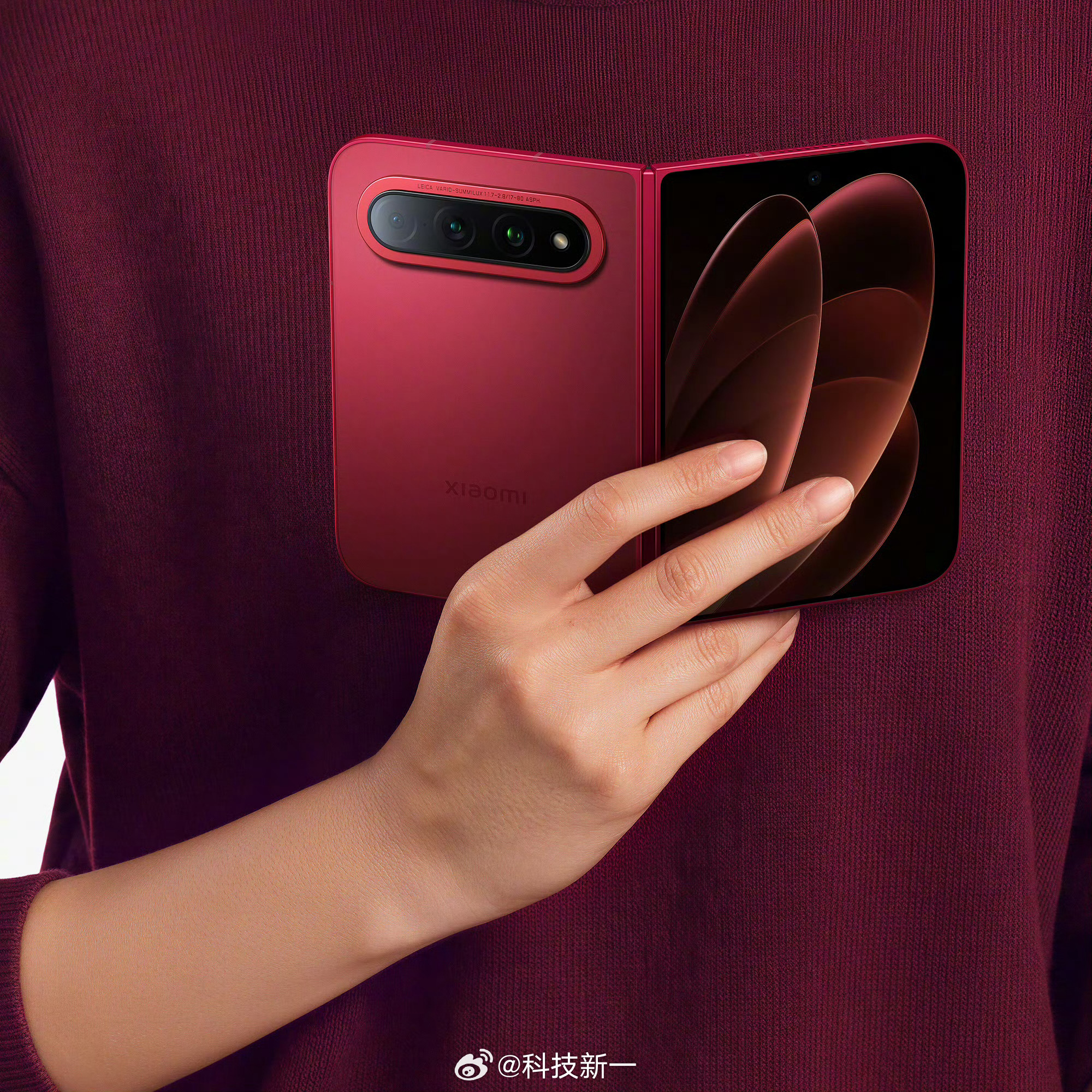 The Xiaomi 18 Fold opened flat, its inner screen showing an abstract red swirl, with the camera module visible on the back panel. Photo: @科技新一